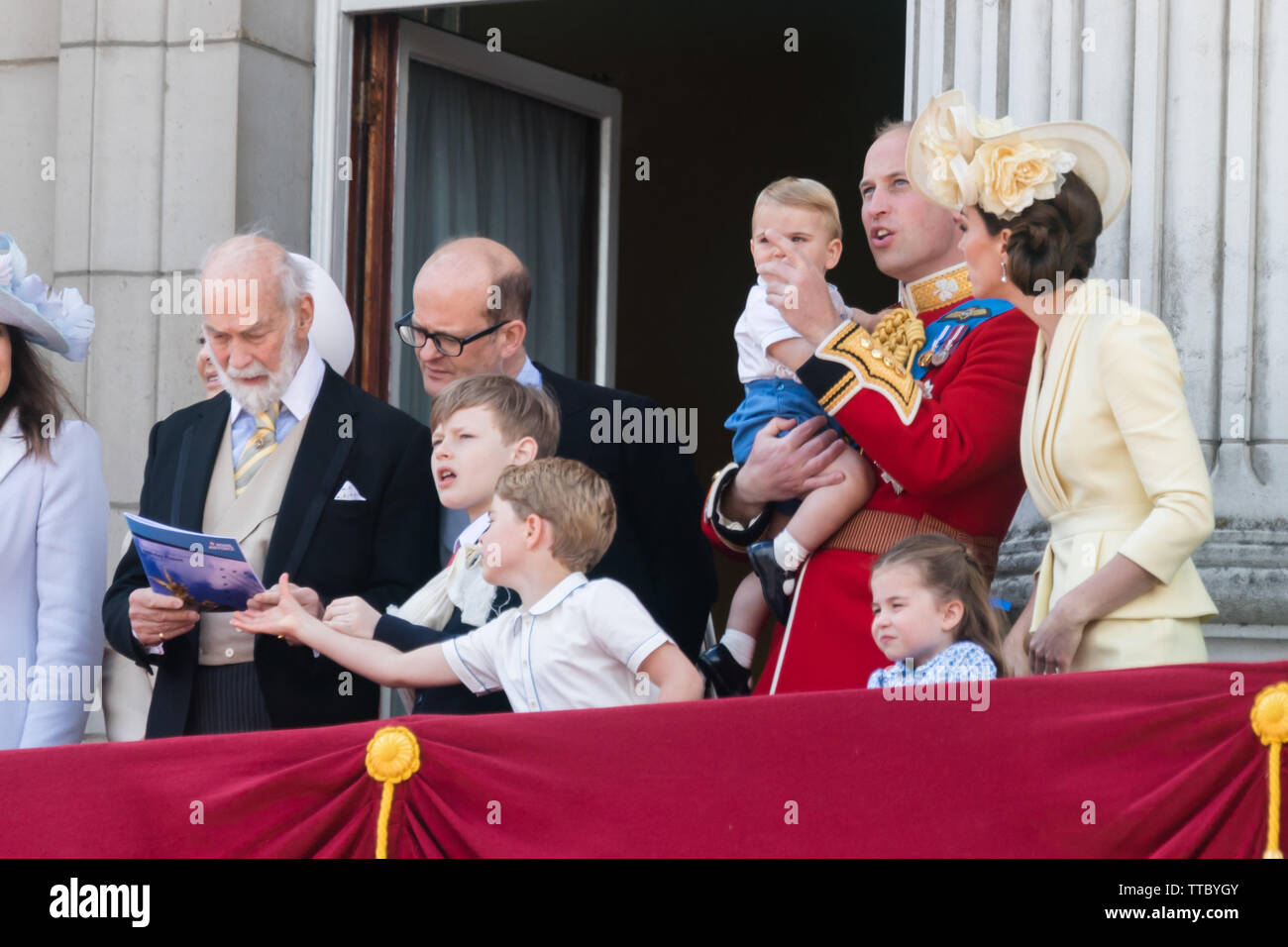 5 year old Prince George of Cambridge grabs the RAF flypast booklet from Prince Michael of Kent's hands.Buckingham Palace Balcony, Trooping the Colour Stock Photo
