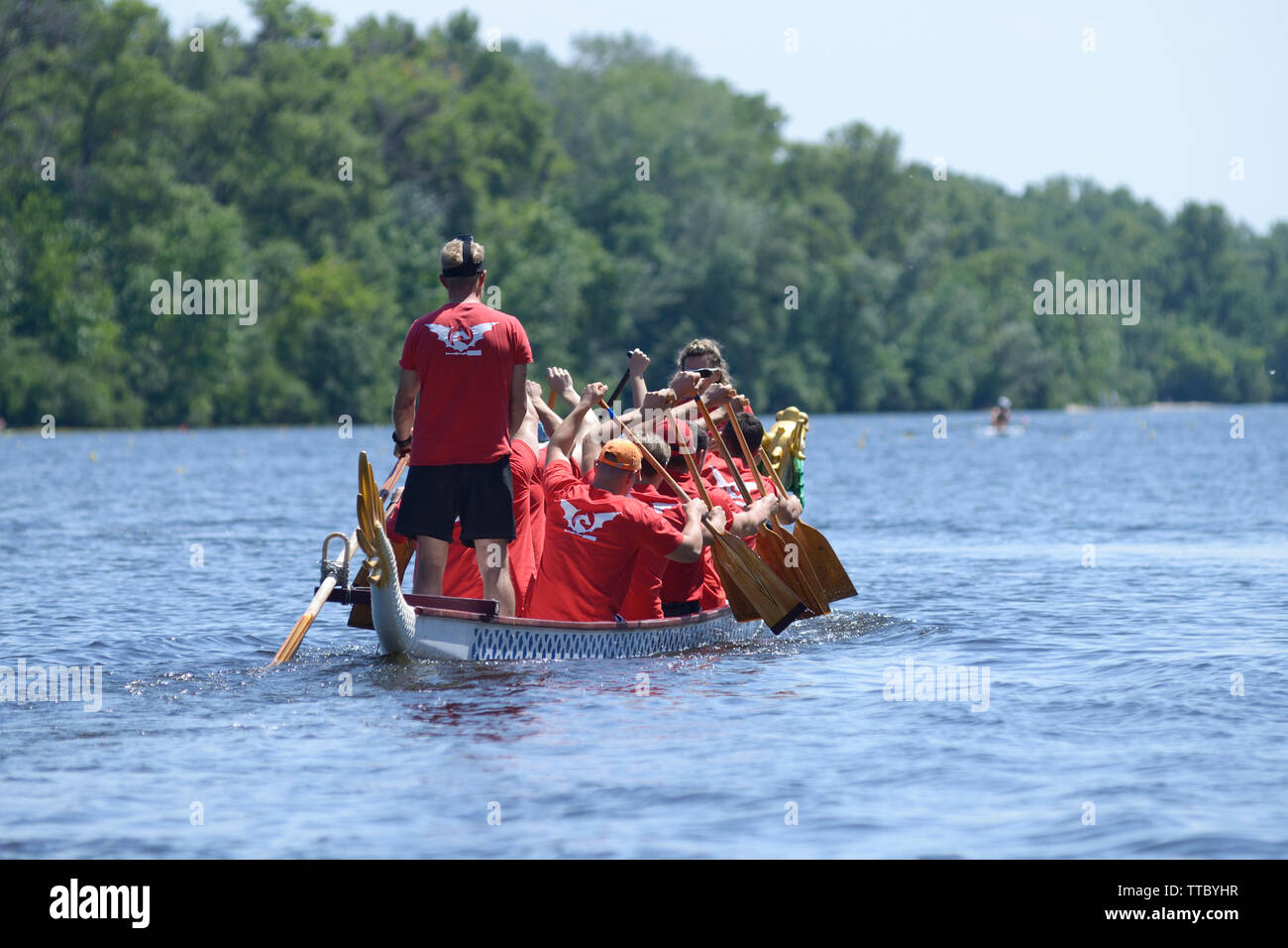 Oarsmen rowing a dragon boat on a river. Kiev oblast championship among amateurs. May 25, 2019. Kiev, Ukraine Stock Photo