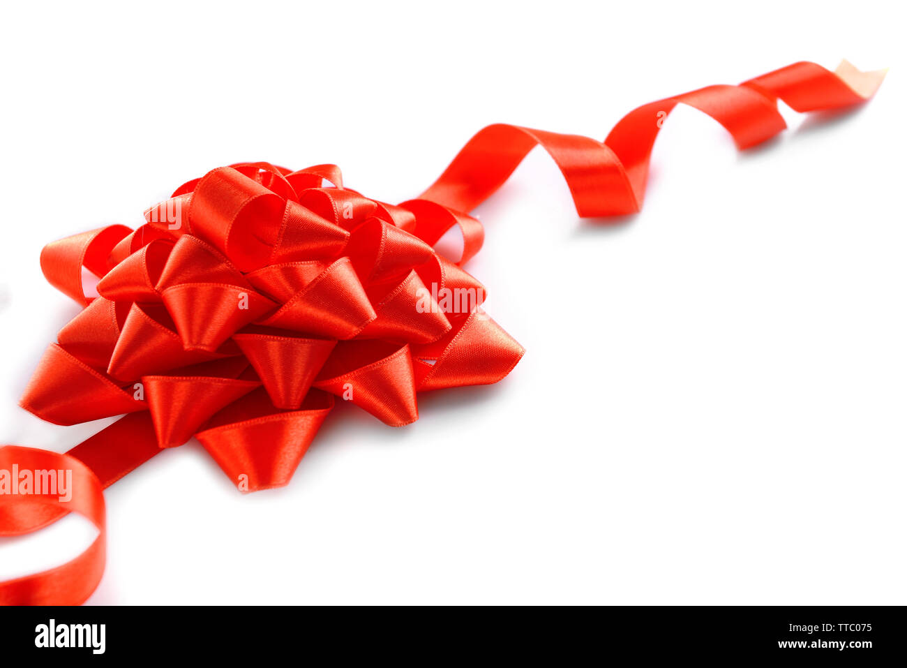 Red bow with curved ribbon isolated on white background Stock Photo