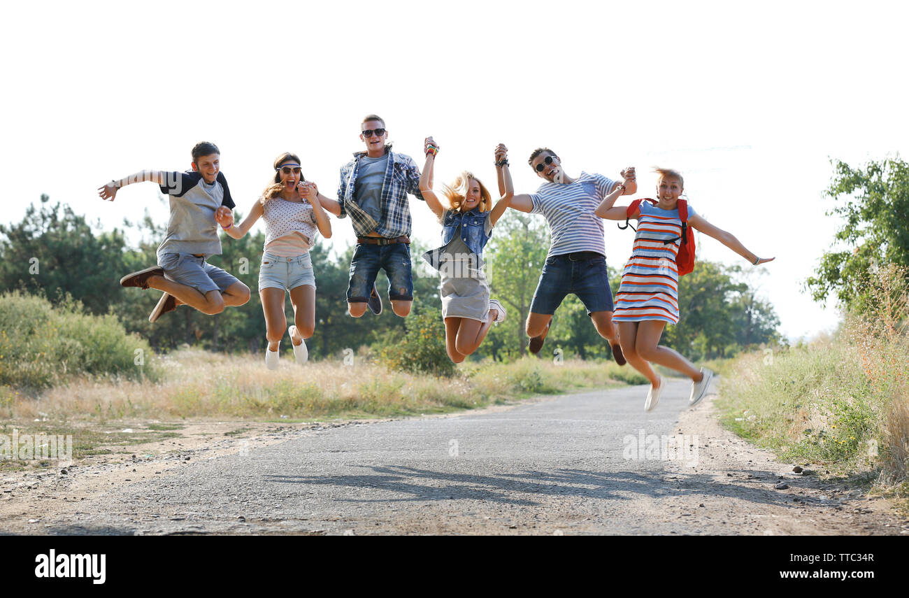 Happy friends jumping together, outdoors Stock Photo - Alamy