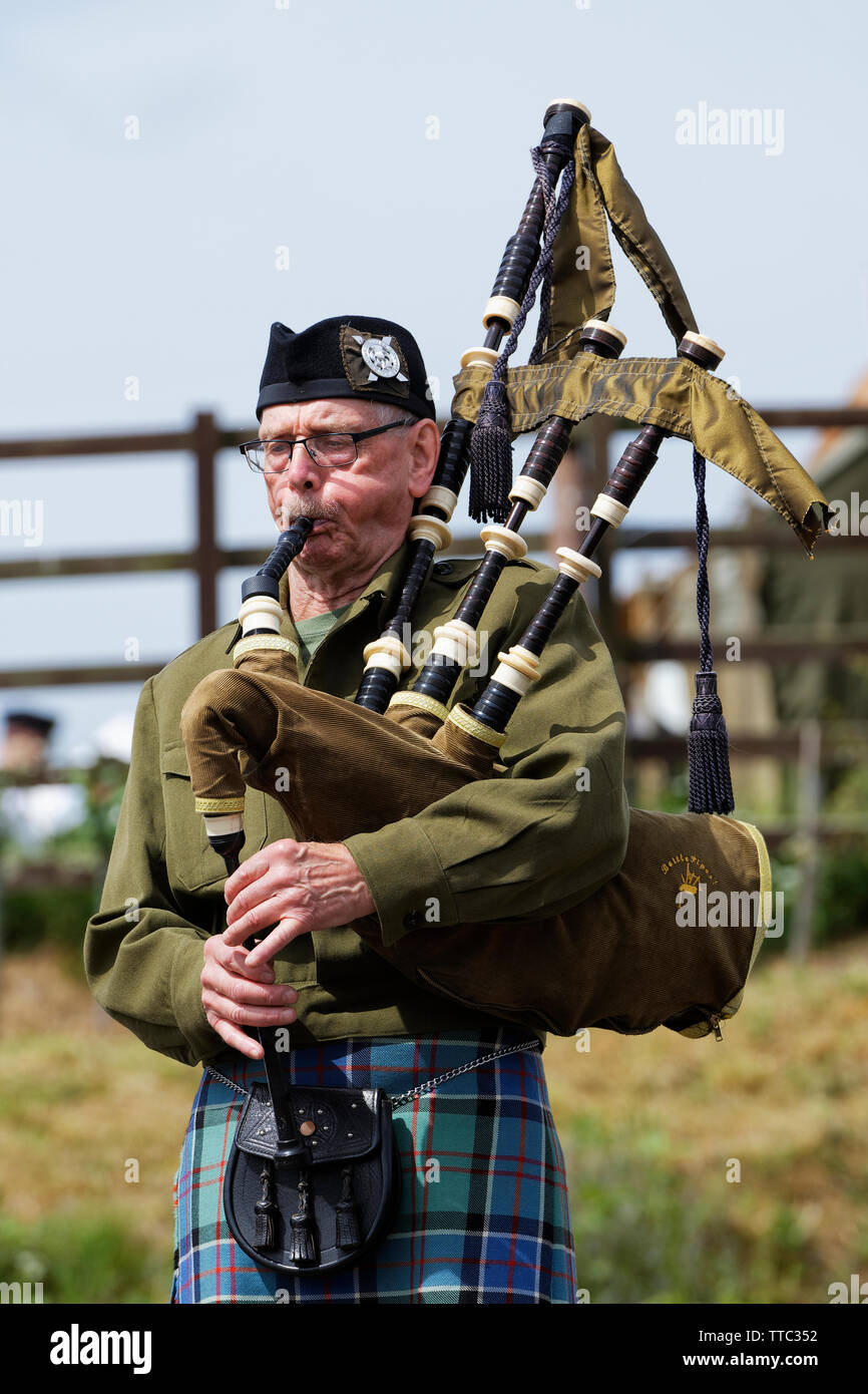 Man playing Battle Bagpipes Stock Photo