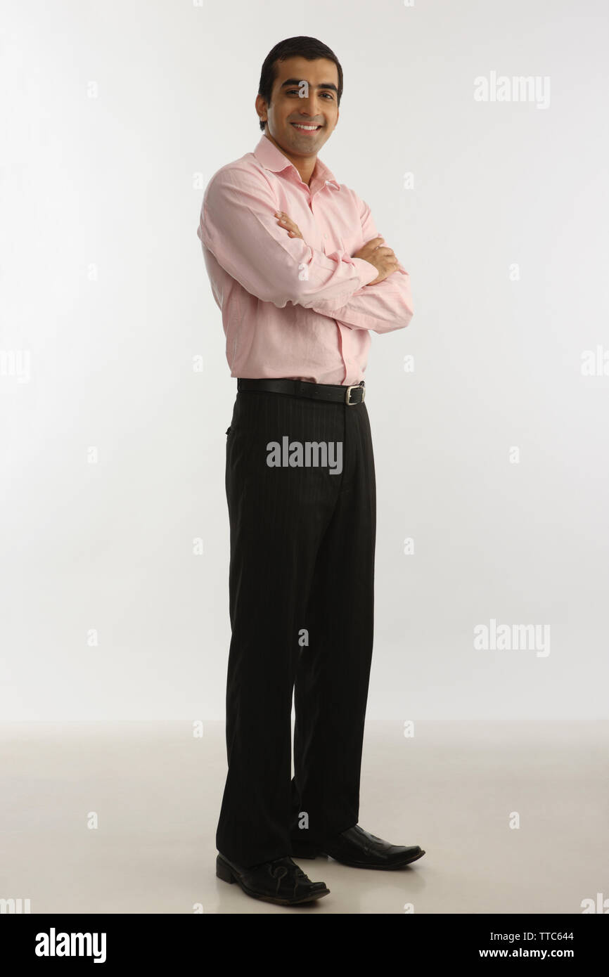 Portrait of a man smiling with arms crossed Stock Photo - Alamy
