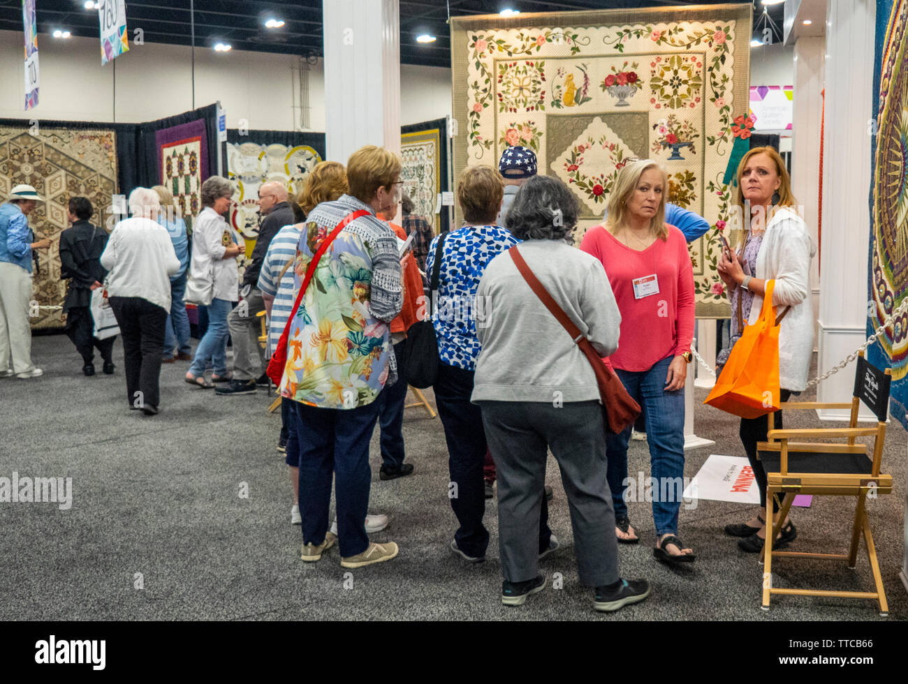 Female quilters viewing quilts on display at Spring Quilt Show 2019 Paducah Kentucky USA Stock Photo