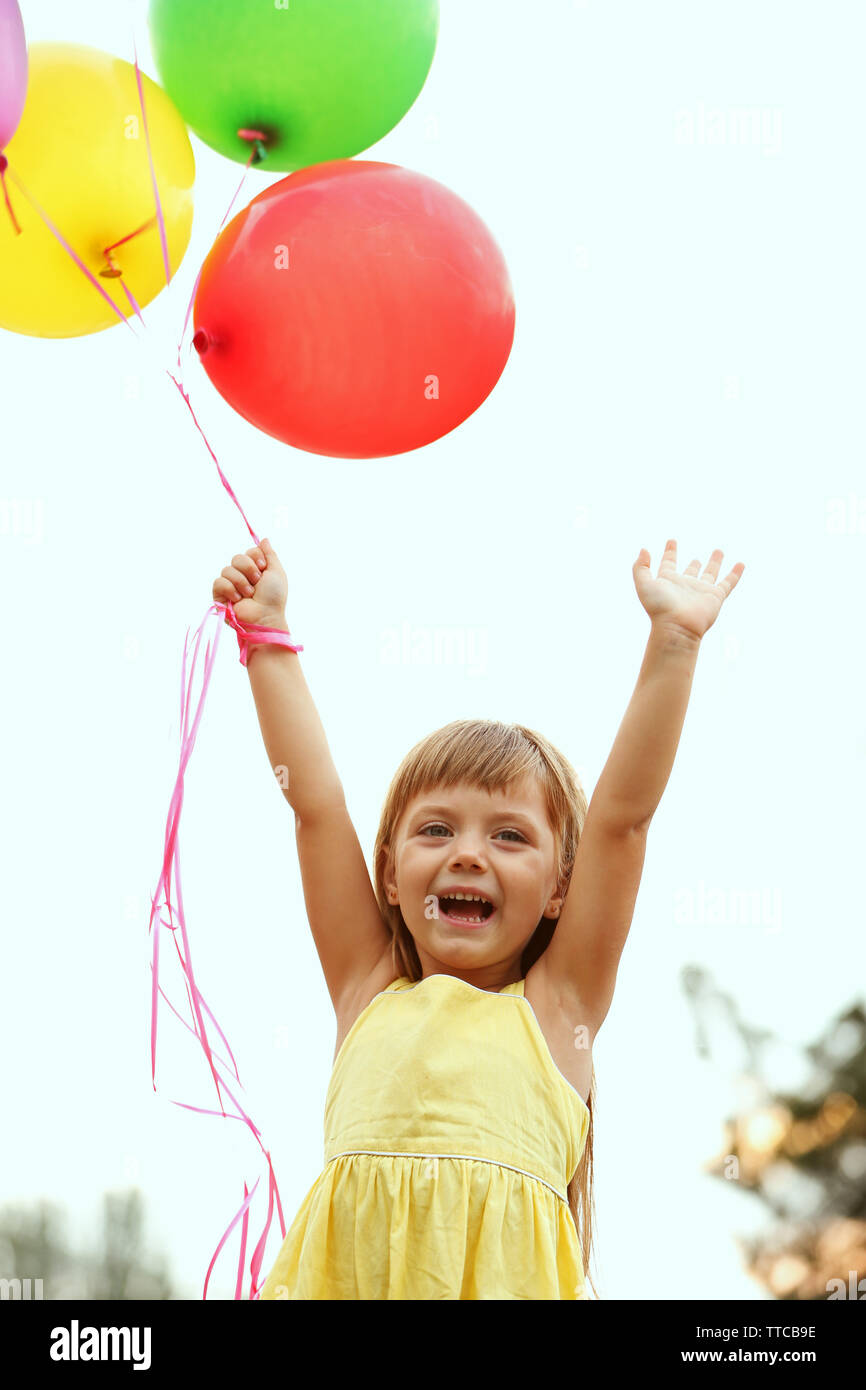 Little girl with balloons outside Stock Photo - Alamy
