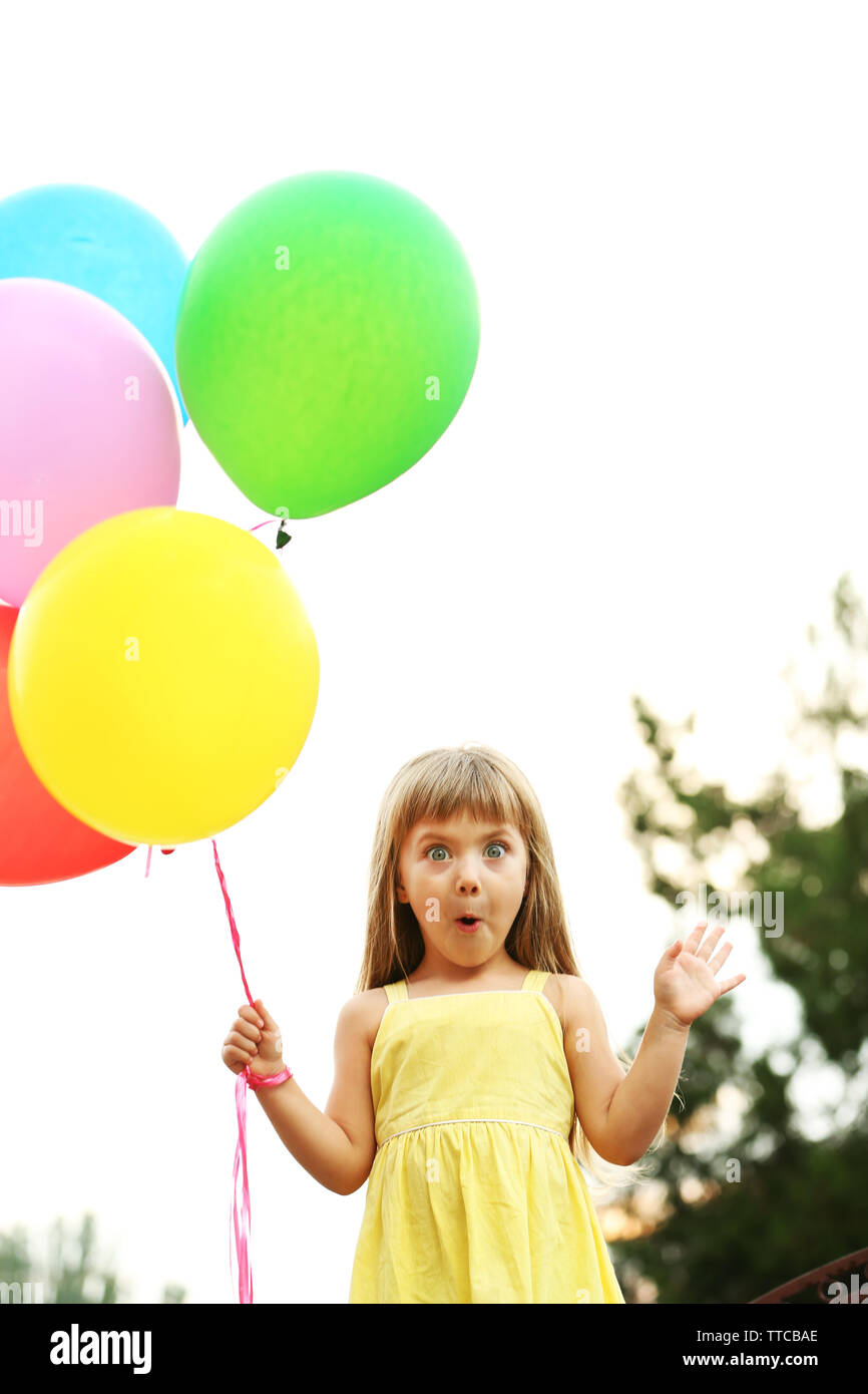 Little girl with balloons outside Stock Photo - Alamy