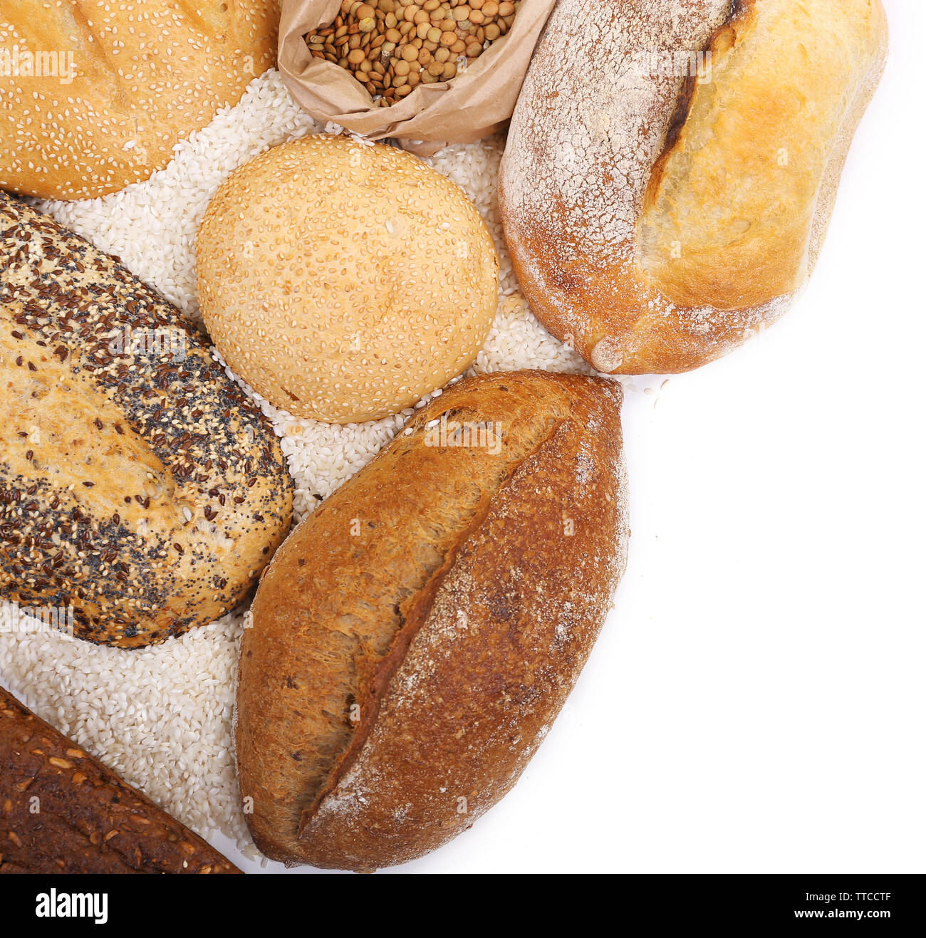 Composition of mixed breads and grains on white background Stock Photo