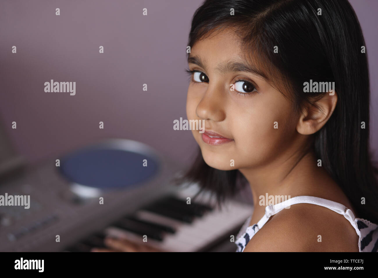 Girl playing a synthesizer Stock Photo