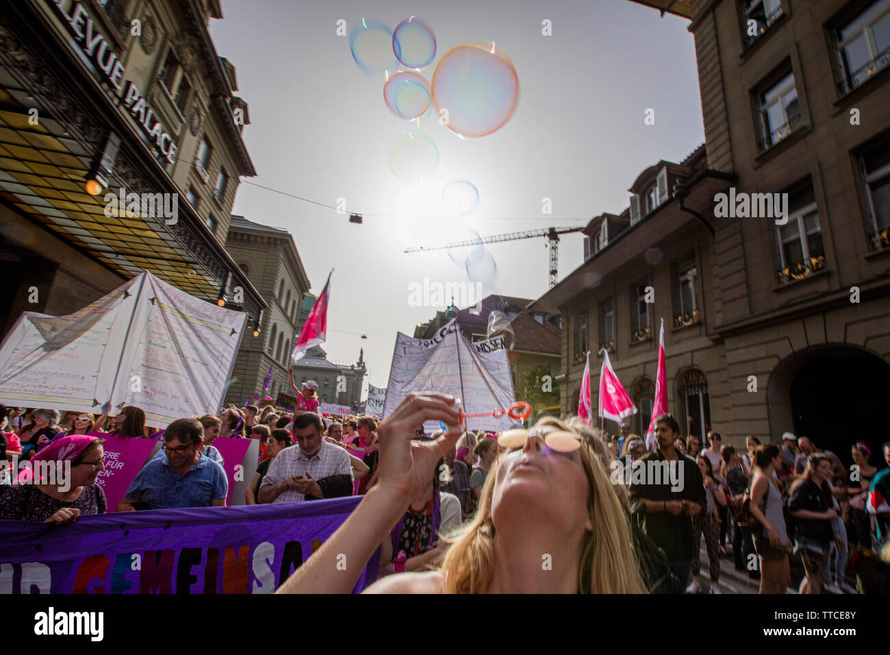 Annina Michel from Bern blows soap bubbles in the Frauenstreik March in Bern. The Frauenstreik - Womens Strike - brought record numbers of women to the streets in all the big cities in Switzerland. In the capitol Bern, more than 40.000 marched throughout the city to fight for gender equality. Stock Photo