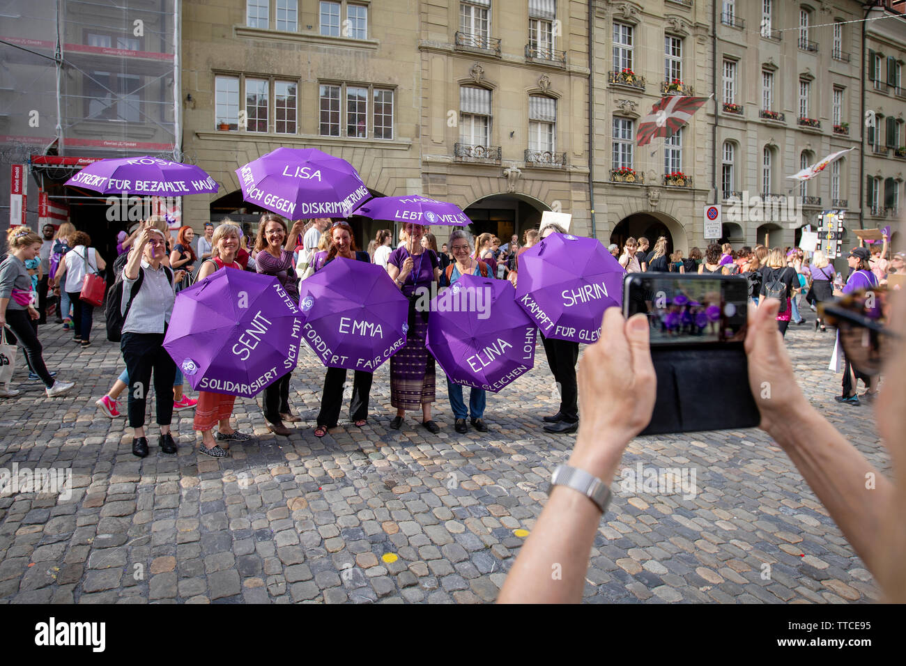 Women in the group 'FAM gegen Rasissmus' pose for a picture during the Frauenstreik march in Bern. The Frauenstreik - Womens Strike - brought record numbers of women to the streets in all the big cities in Switzerland. In the capitol Bern, more than 40.000 marched throughout the city to fight for gender equality. Stock Photo