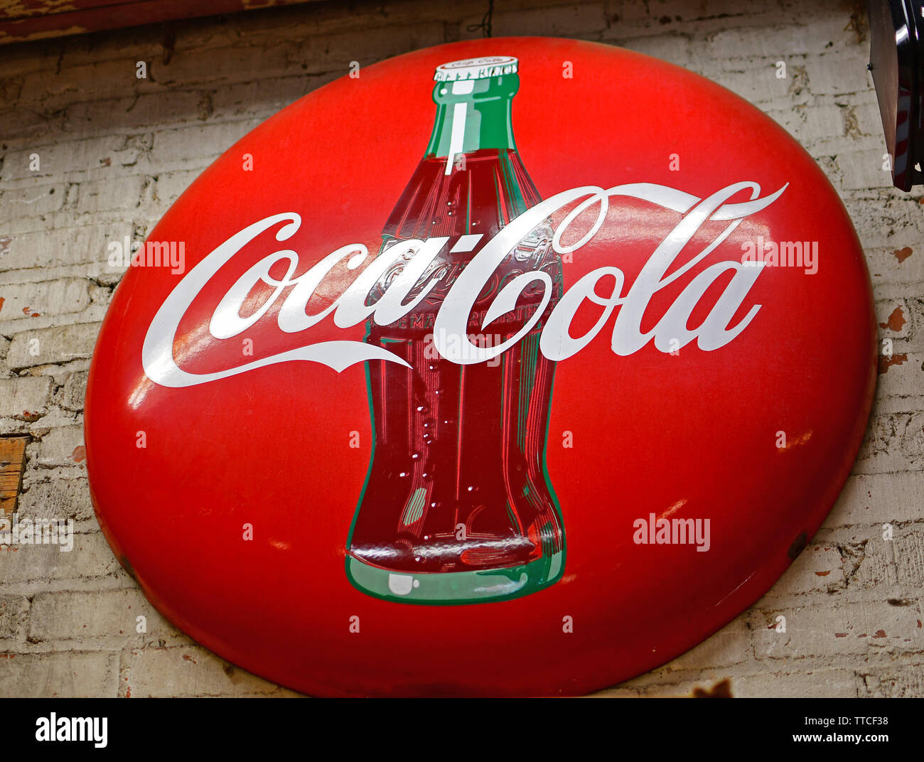 Classic red Coca Cola button sign in a hardware store in North Carolina Stock Photo