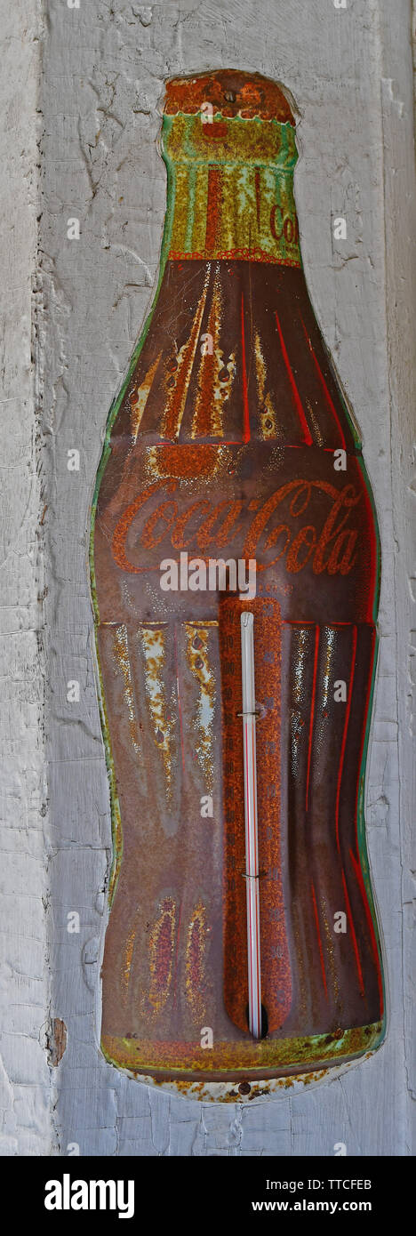 Faded vintage Coca-Cola thermometer ad in a hardware store Stock Photo