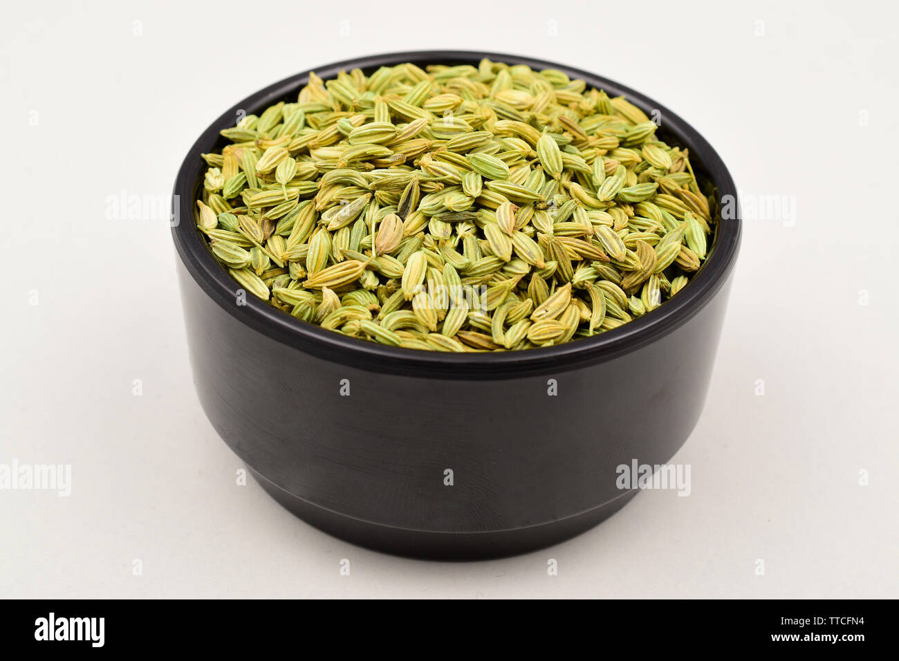 fennel seeds in black bowl isolated on white background Stock Photo Alamy