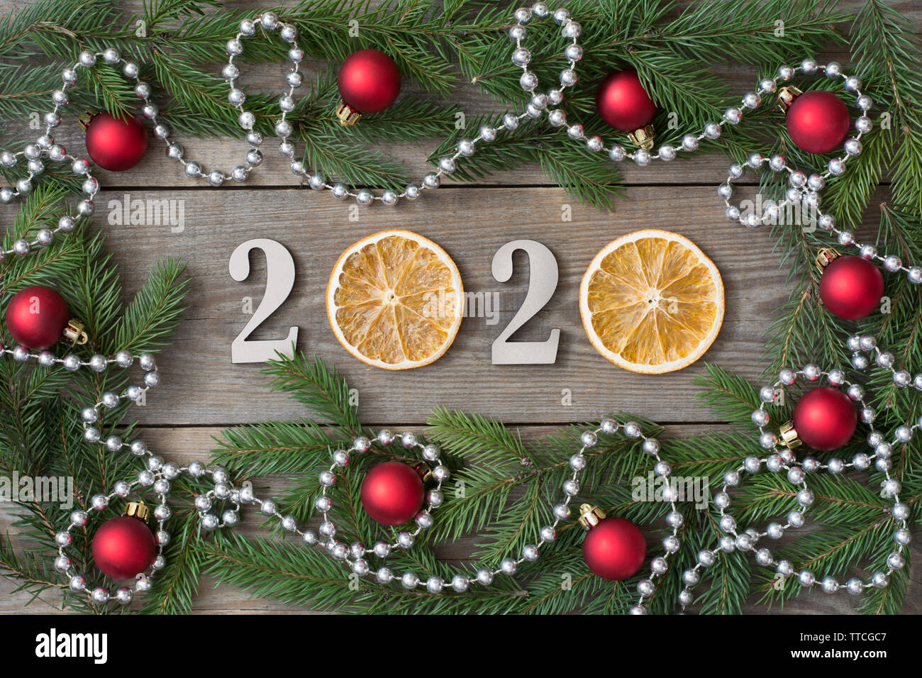 2020 New year rustic background with orange slices, fir tree branches ...