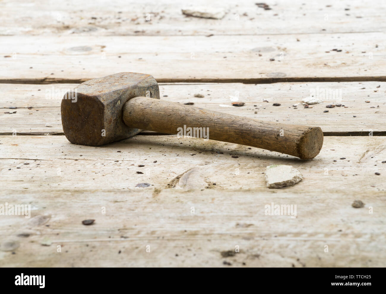 Lump hammer resting on wooden scaffolding planks on a building / construction site. Potential copy space above and under hammer. Stock Photo