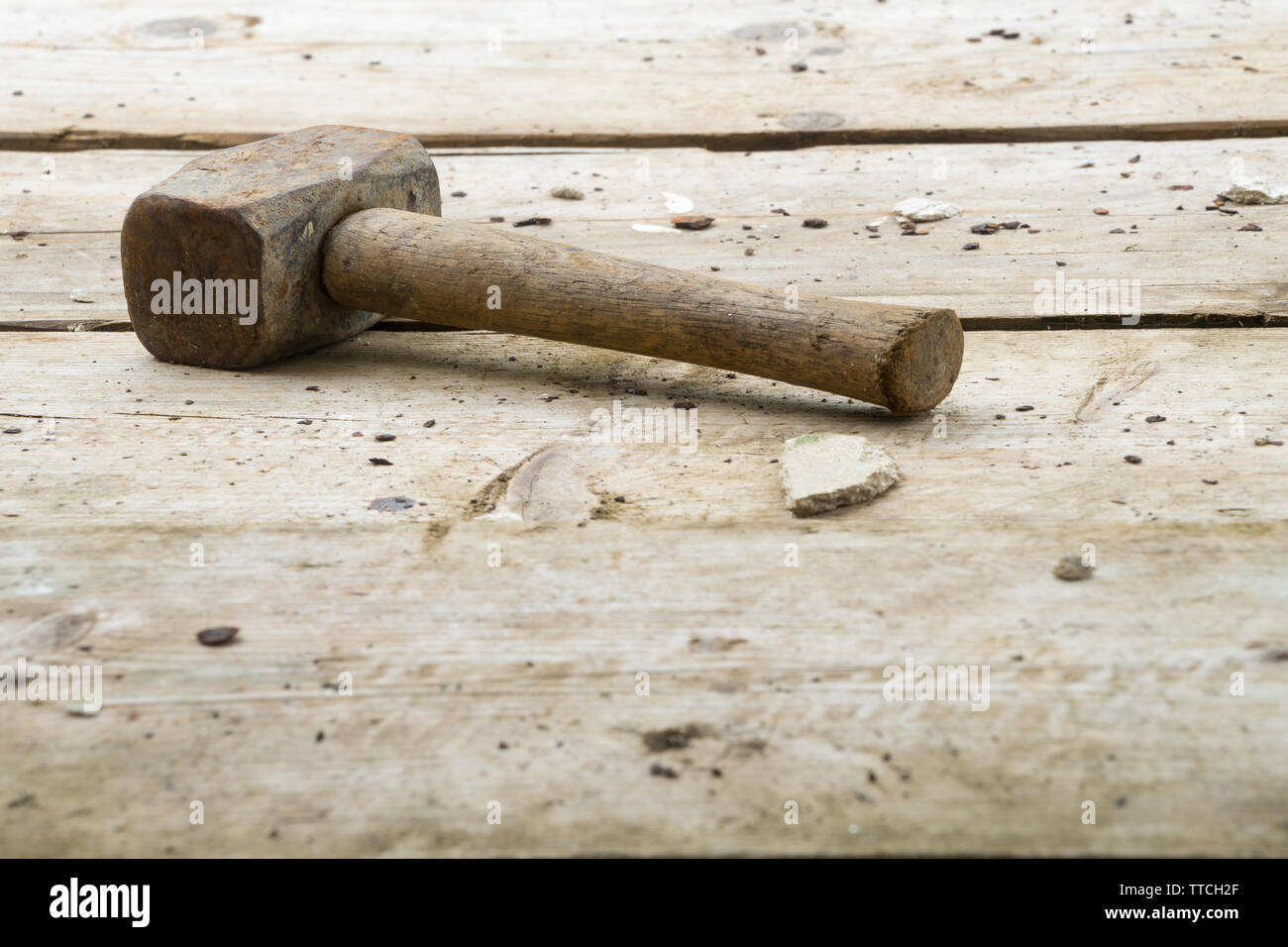 Builder's lump hammer resting on wooden scaffolding planks on a construction site. Potential copy space under hammer. Stock Photo