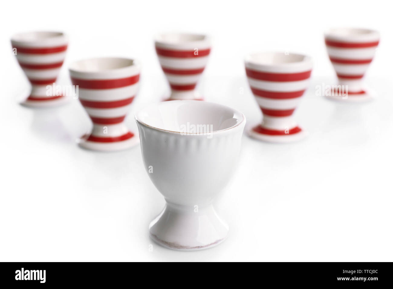 Red and White stripe egg cups, isolated on white Stock Photo
