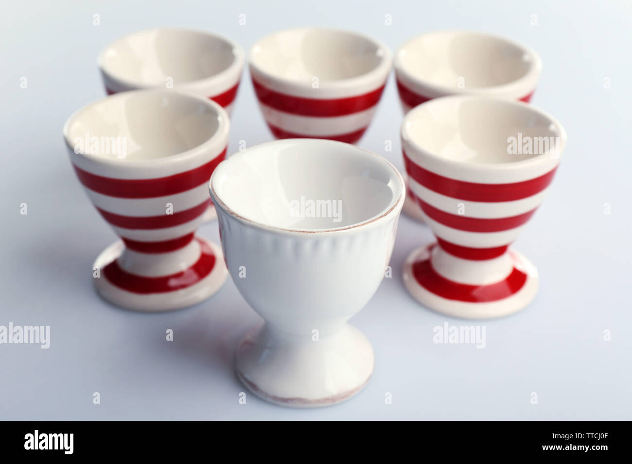 Red and White stripe egg cups, isolated on white Stock Photo