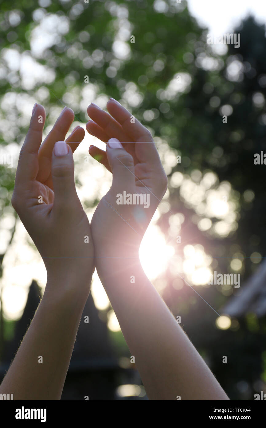 Hands on sunlight background Stock Photo - Alamy