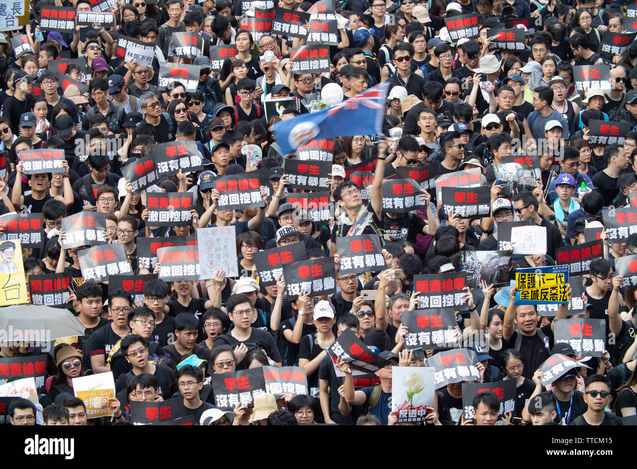 Hong Kong, Hong Kong. 16 June, 2019. Protesters march carrying signs decrying the police violence of previous marches and their declaration as a riot. Credit: Danny Tsai/Alamy Live News Stock Photo