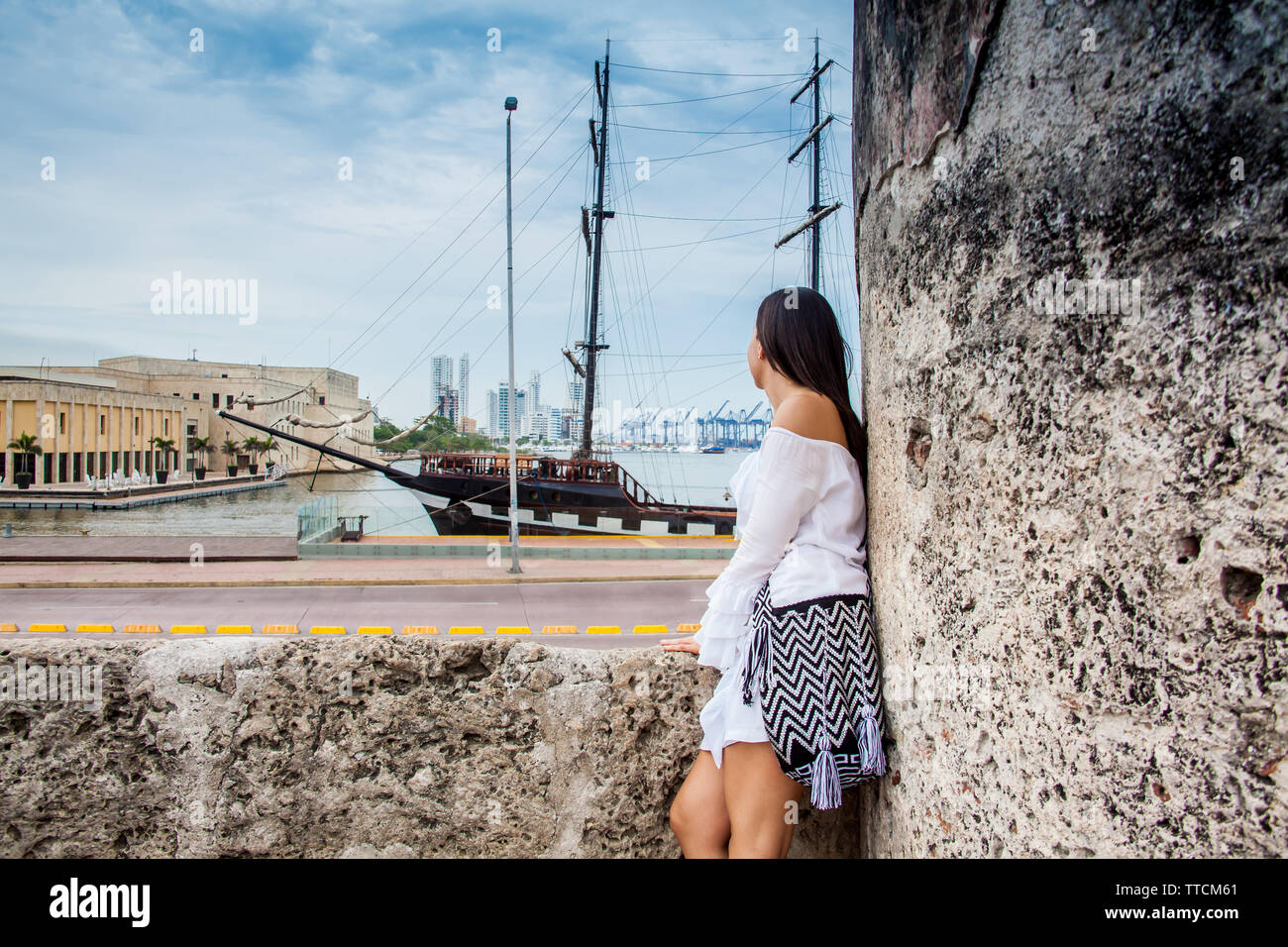 Beautiful woman standing at the walls of Cartagena de Indias looking to the bay Stock Photo