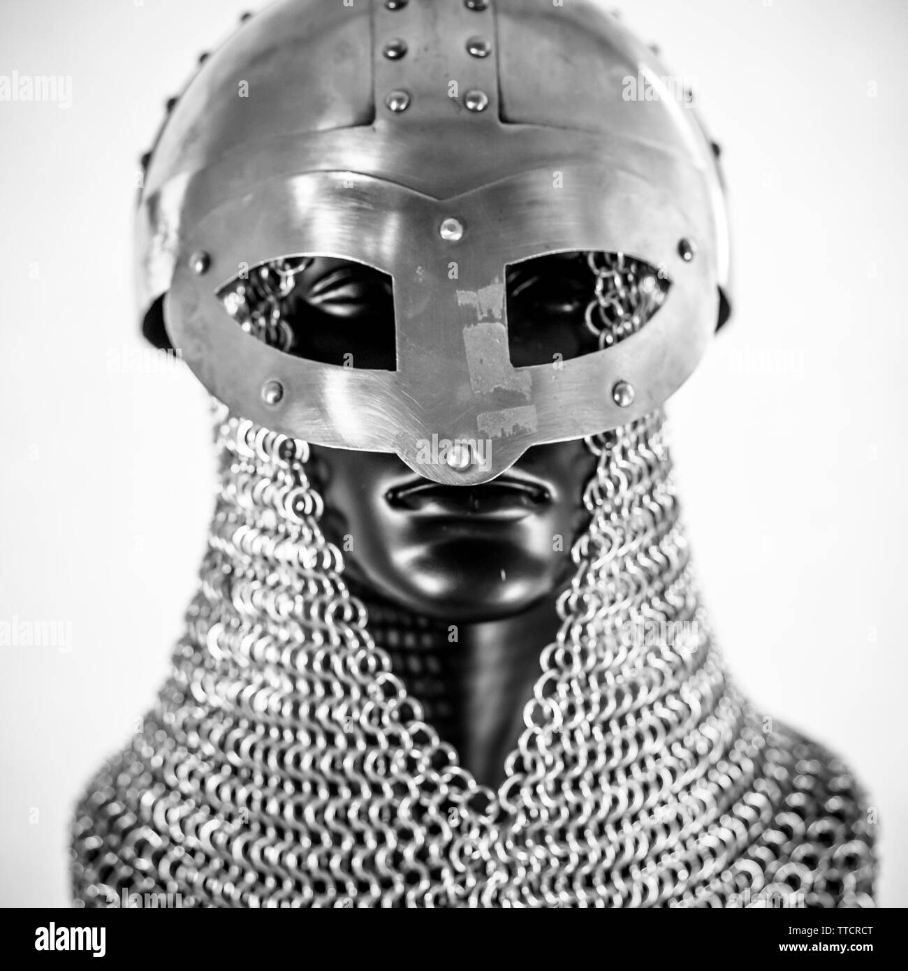 Metal, Viking helmet with chain mail in a black mannequin on white background. clothes for the viking war Stock Photo