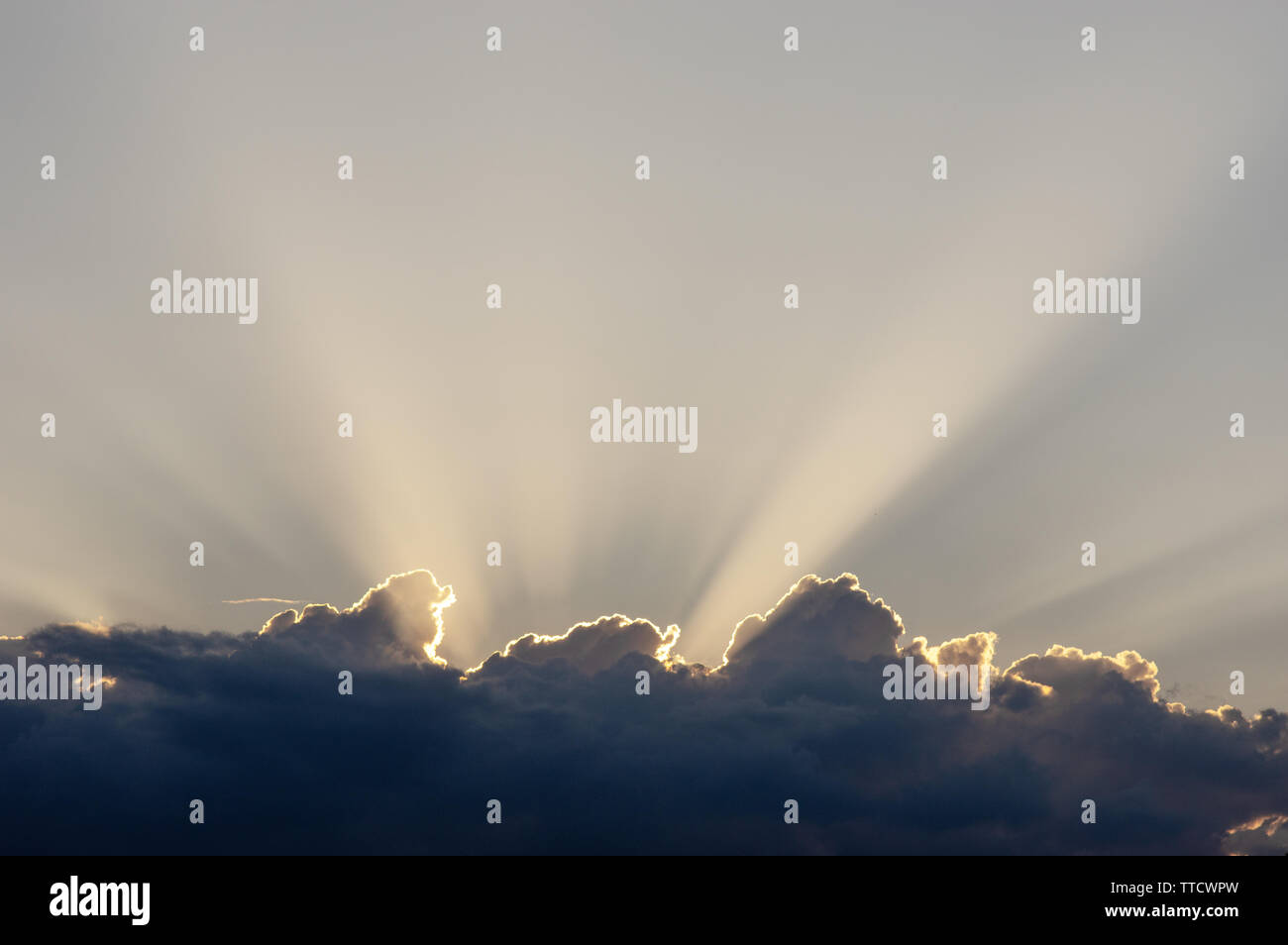 Sun behind a cloud, with cloud rays Stock Photo