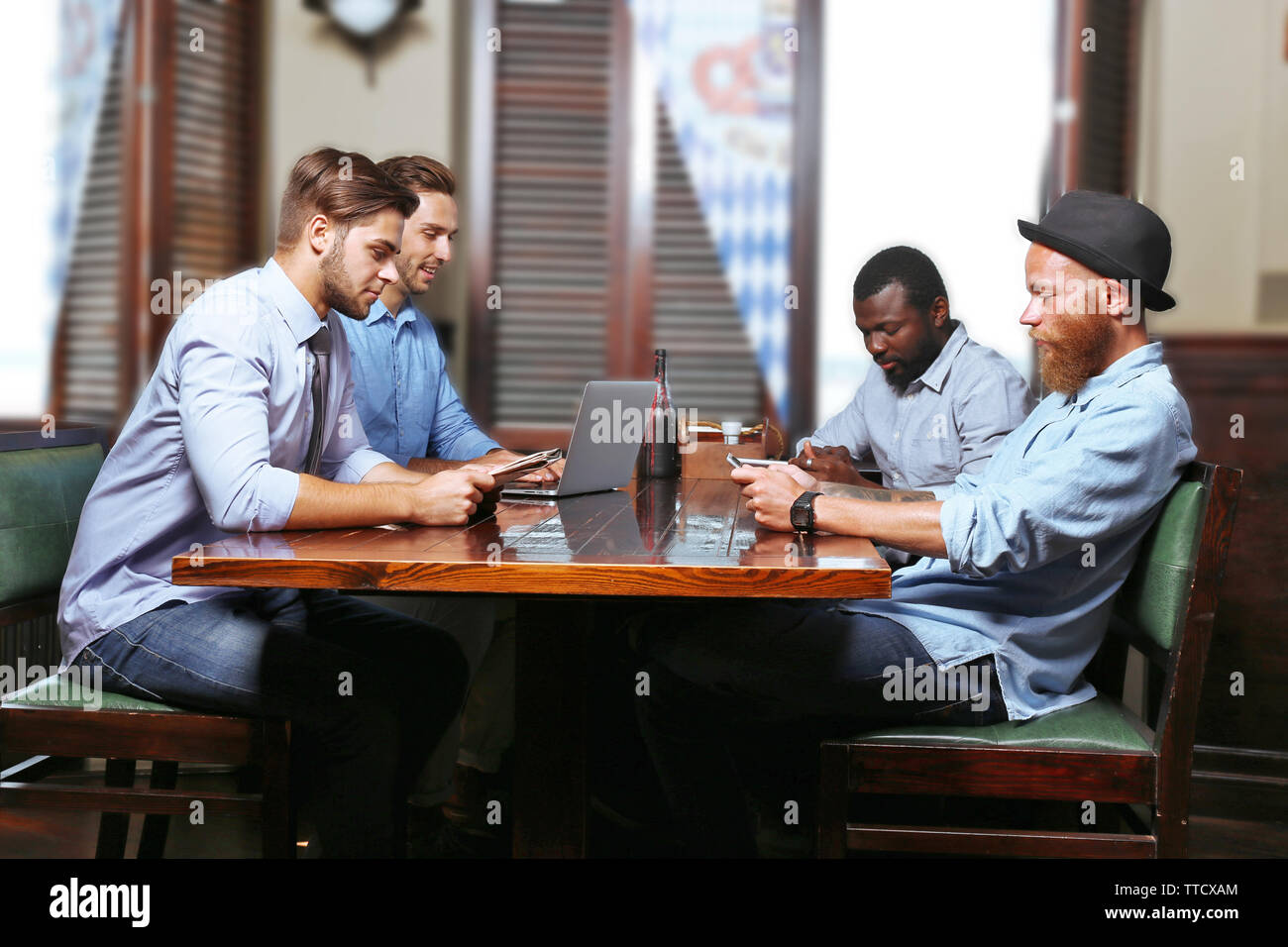 Young men talking in cafe Stock Photo