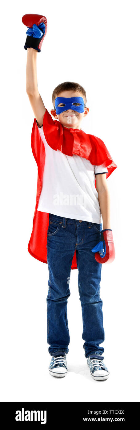 Boy dressed as superhero with boxing gloves poses in studio  isolated on white background Stock Photo