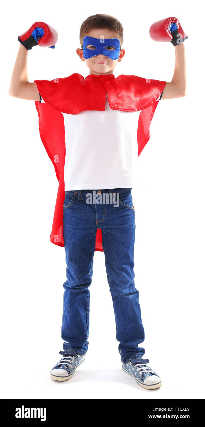 Boy dressed as superhero with boxing gloves poses in studio isolated on