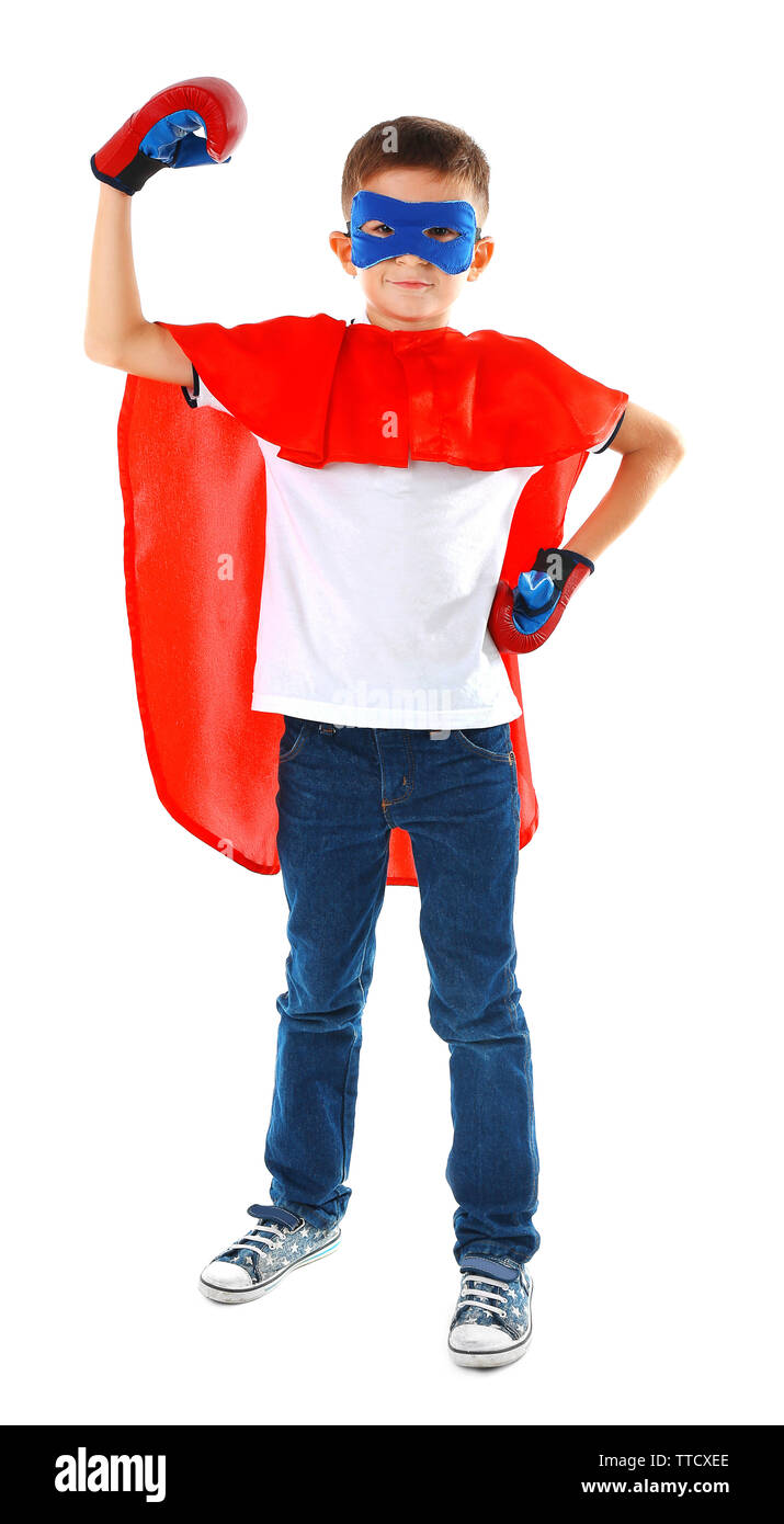 Boy dressed as superhero with boxing gloves poses in studio isolated on