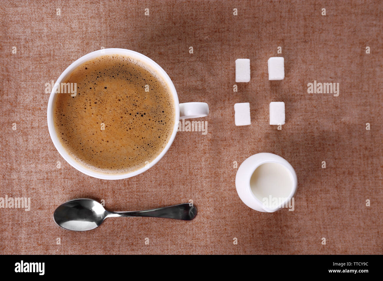 Cup of coffee with cream and sugar on sackcloth Stock Photo Alamy