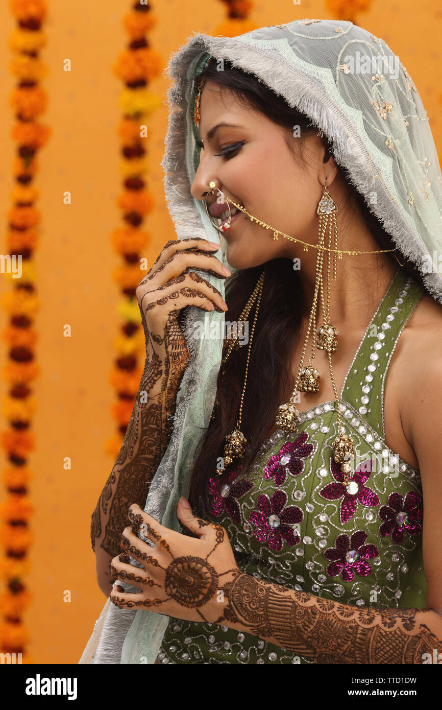 Indian bride wearing a stole smiling Stock Photo