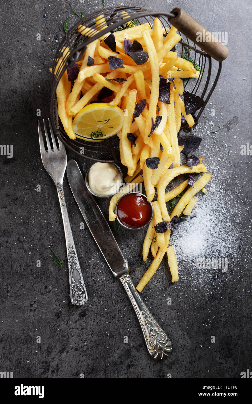 Table Fries French fries with sauce and tableware on table Stock Photo - Alamy