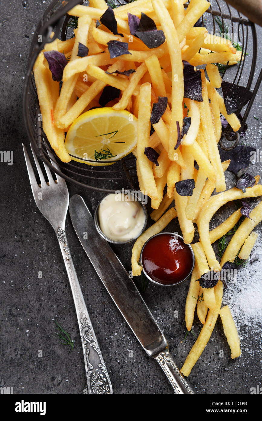 Table Fries French fries with sauce and tableware on table Stock Photo - Alamy