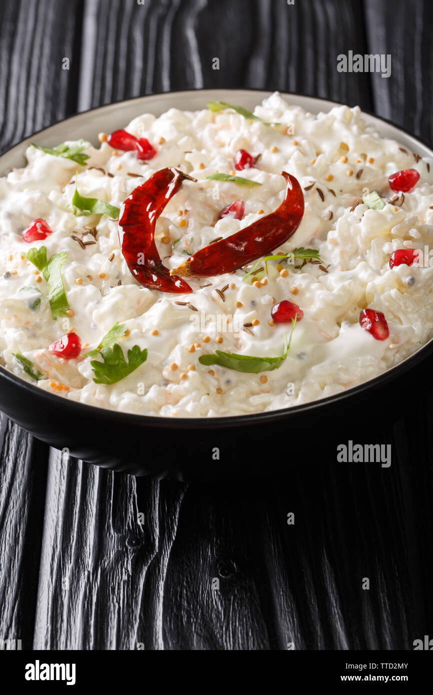 Curd Rice or Perugu Annam recipe is a perfect amalgamation of mild southern spices and sweet-tangy flavours of curd closeup in a plate on the table. V Stock Photo