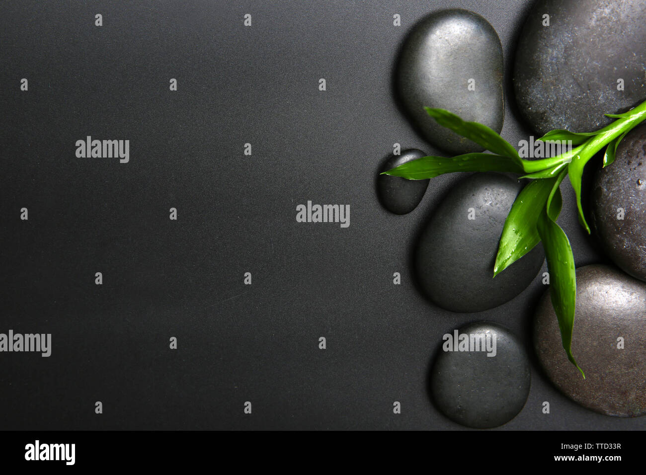 Spa stones and leaves on black background Stock Photo - Alamy