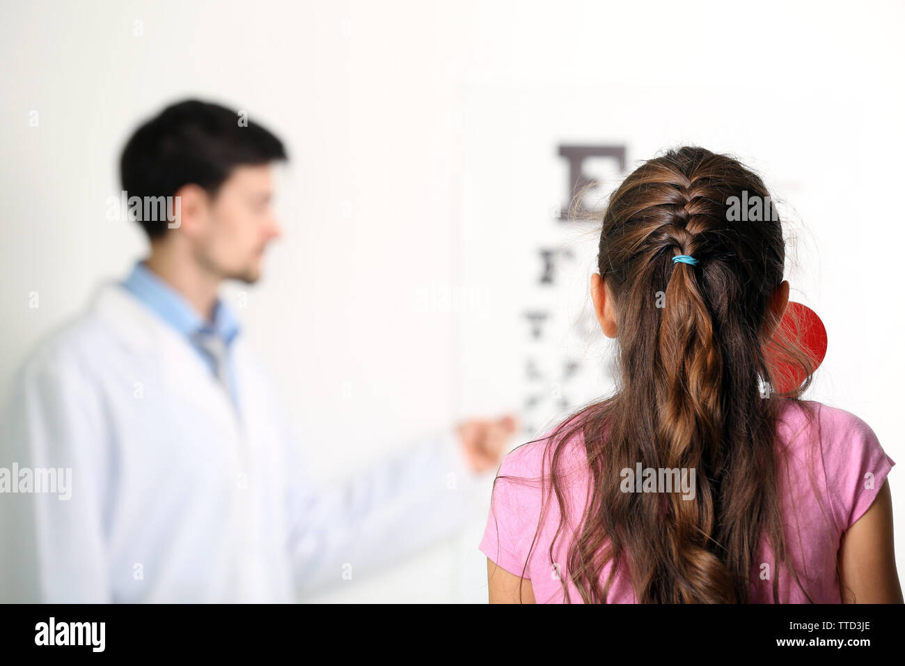 Adult male doctor examing small girl patient Stock Photo - Alamy