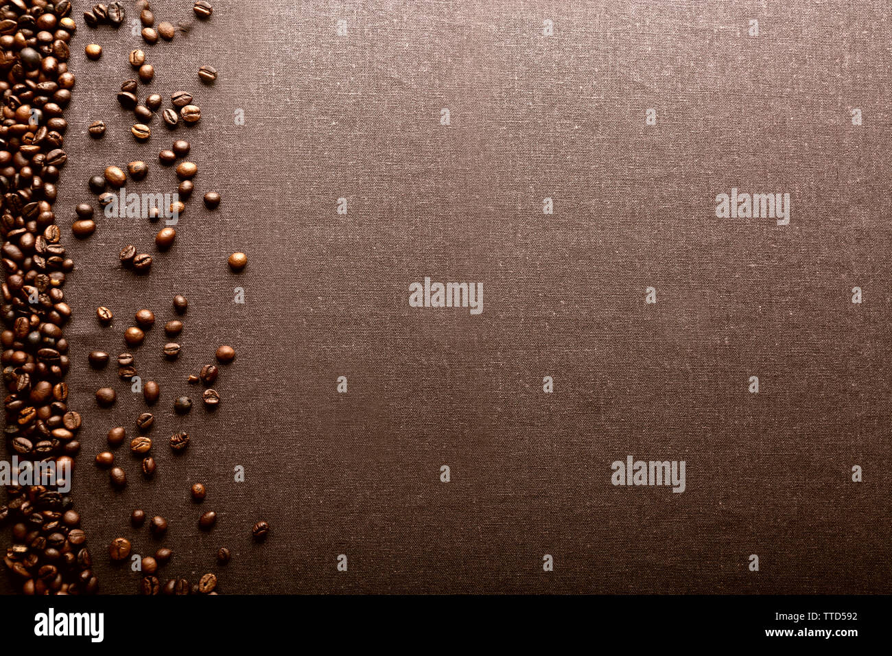 Roasted coffee beans on grey textile background Stock Photo - Alamy