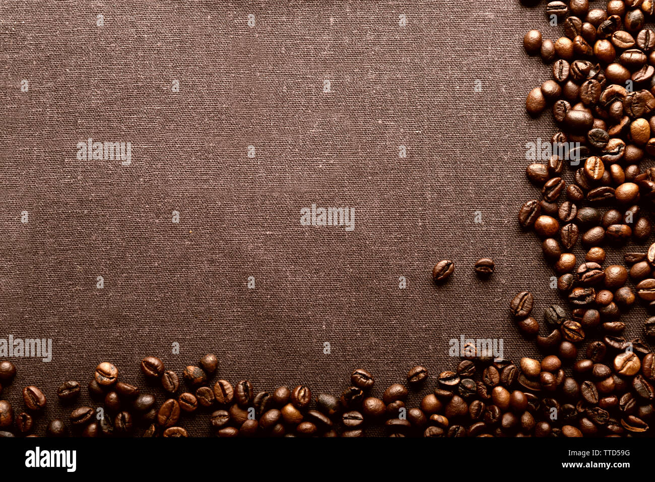 Roasted coffee beans on grey textile background Stock Photo - Alamy