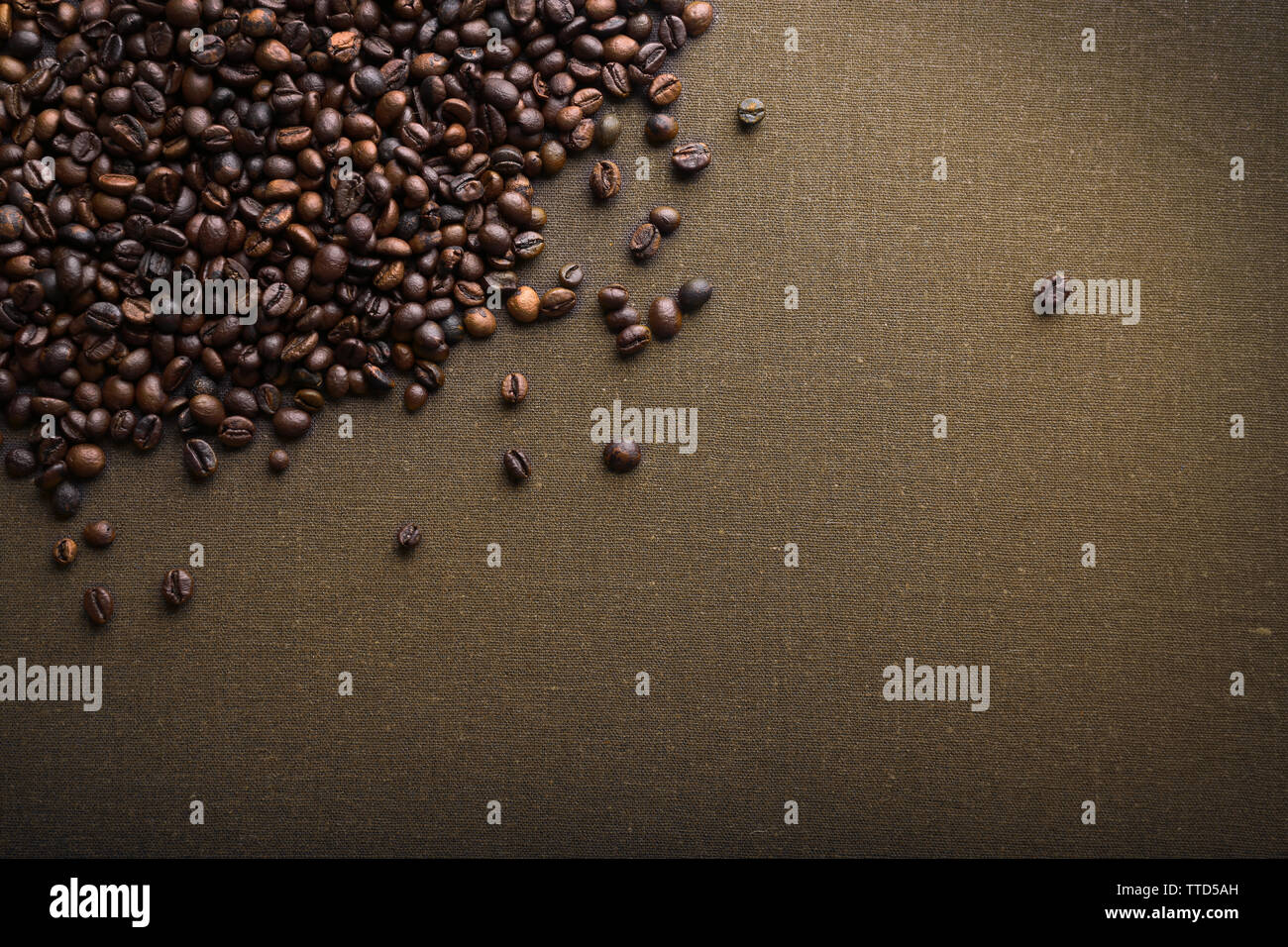 Roasted coffee beans on grey textile background Stock Photo - Alamy