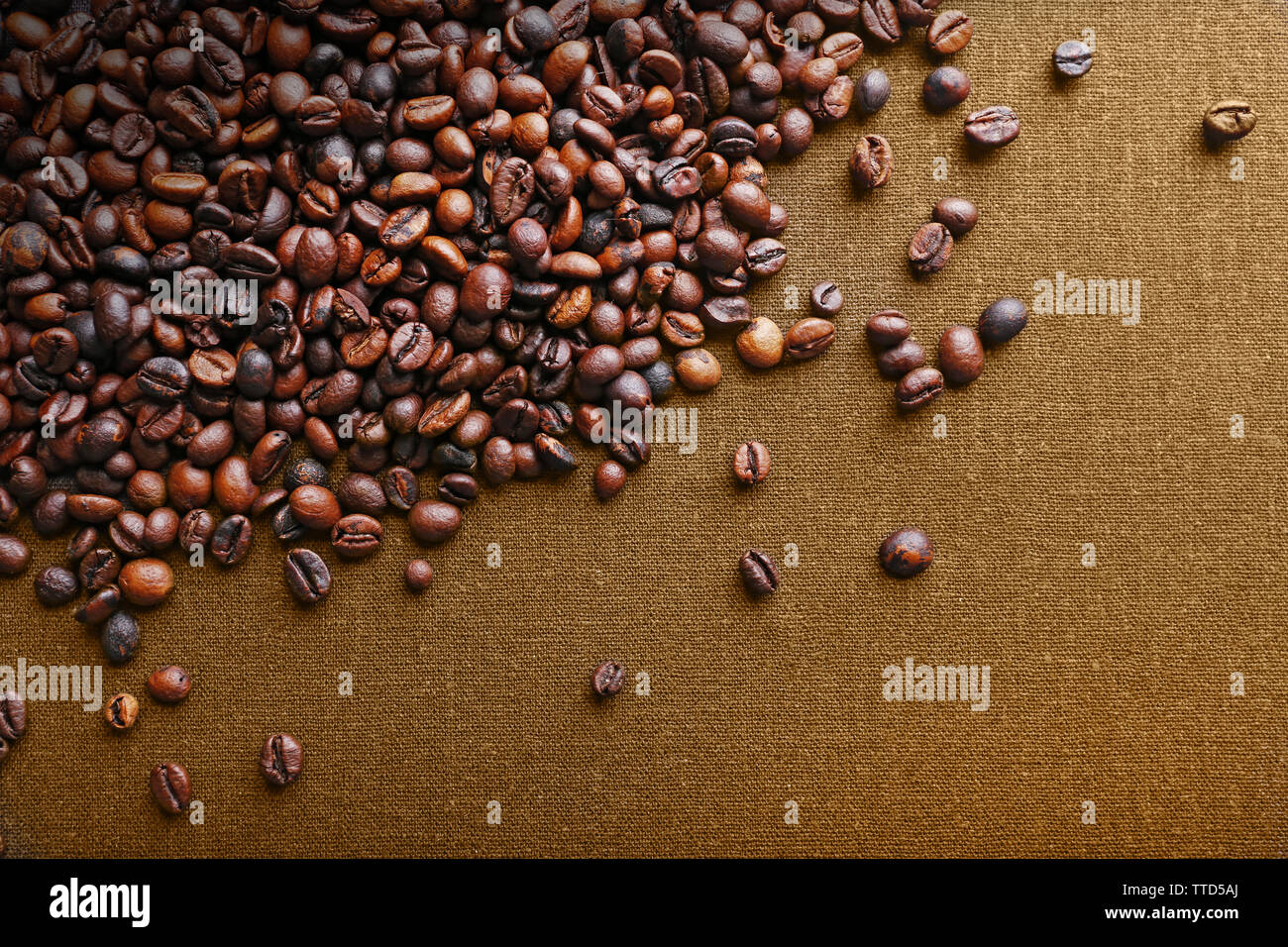 Roasted coffee beans on grey textile background Stock Photo - Alamy