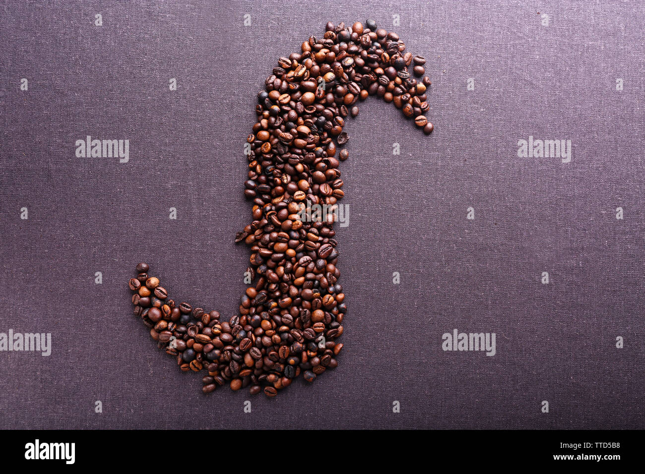 Roasted coffee beans on grey textile background Stock Photo - Alamy