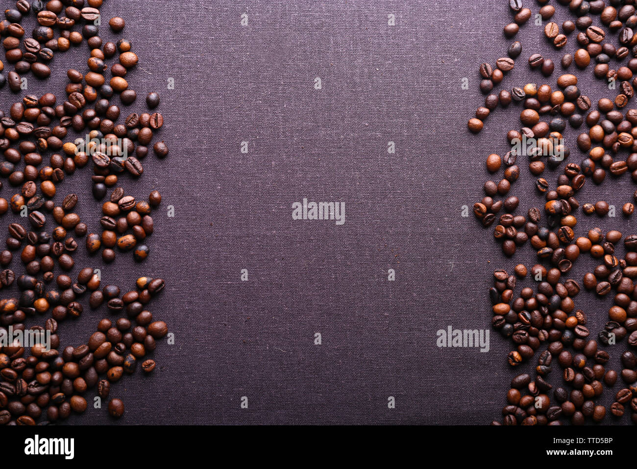 Roasted coffee beans on grey textile background Stock Photo - Alamy