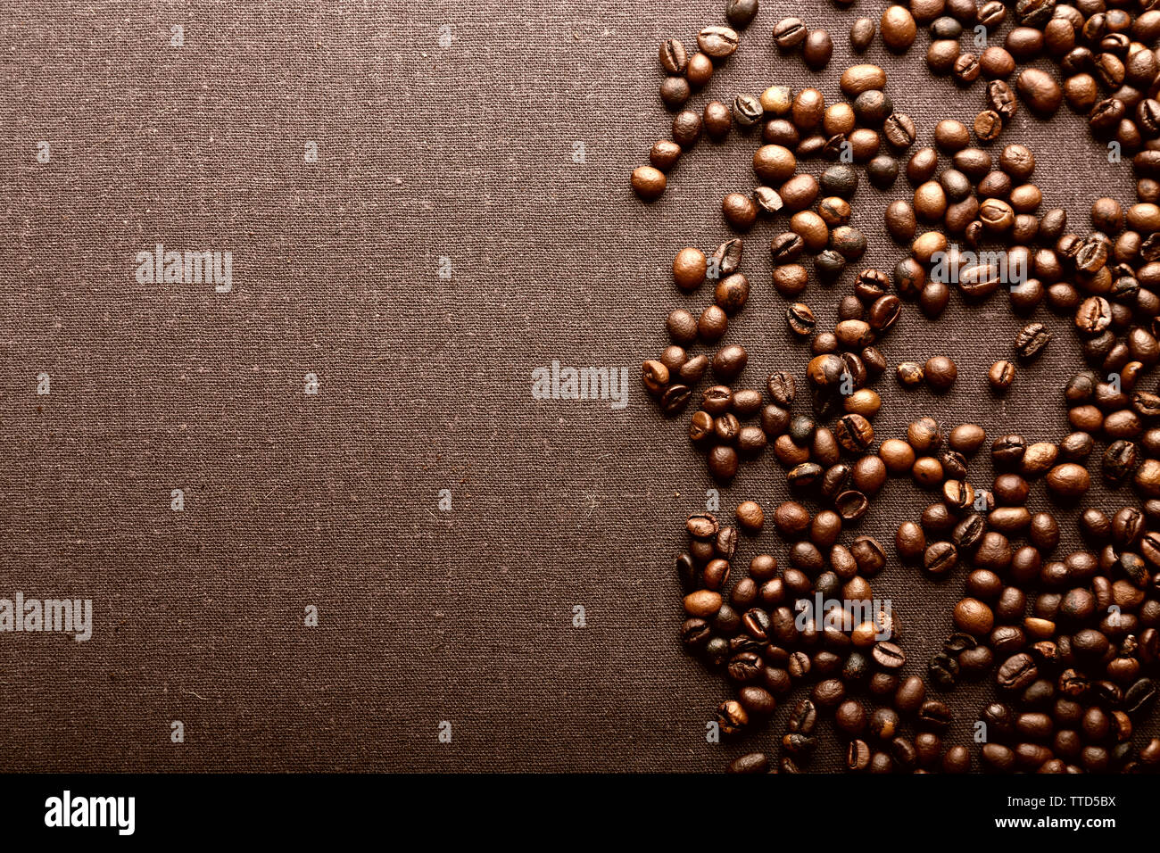 Roasted coffee beans on grey textile background Stock Photo - Alamy