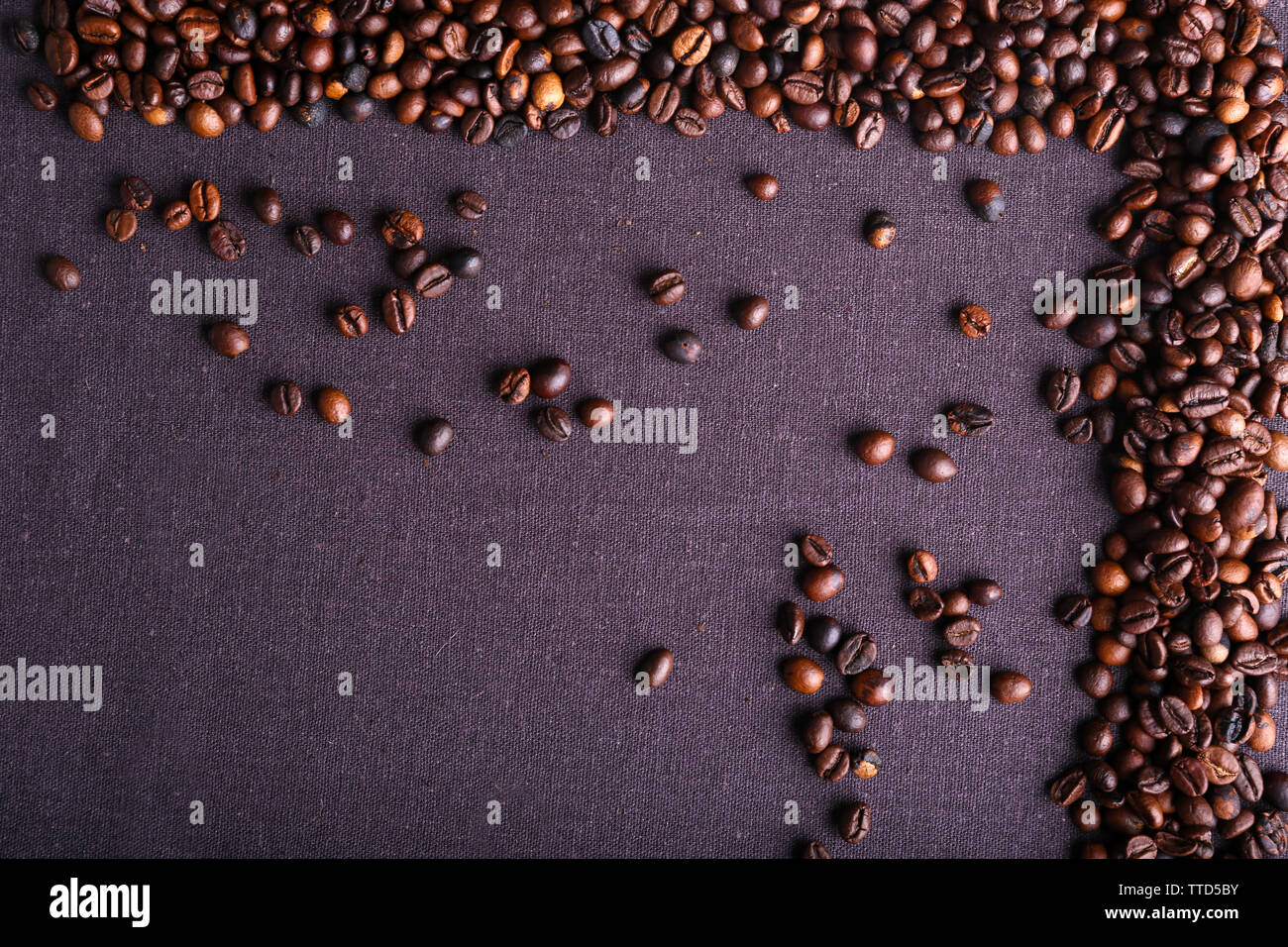 Roasted coffee beans on grey textile background Stock Photo - Alamy