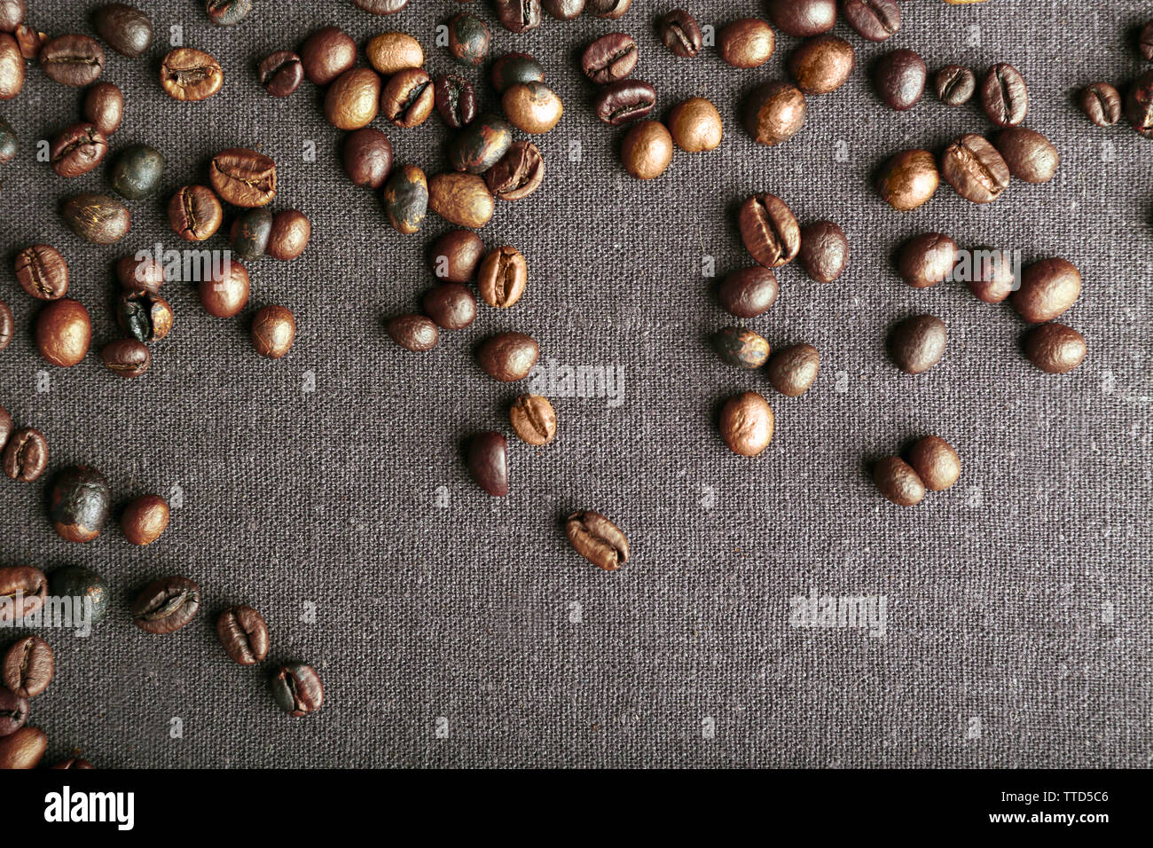 Roasted coffee beans on grey textile background Stock Photo - Alamy
