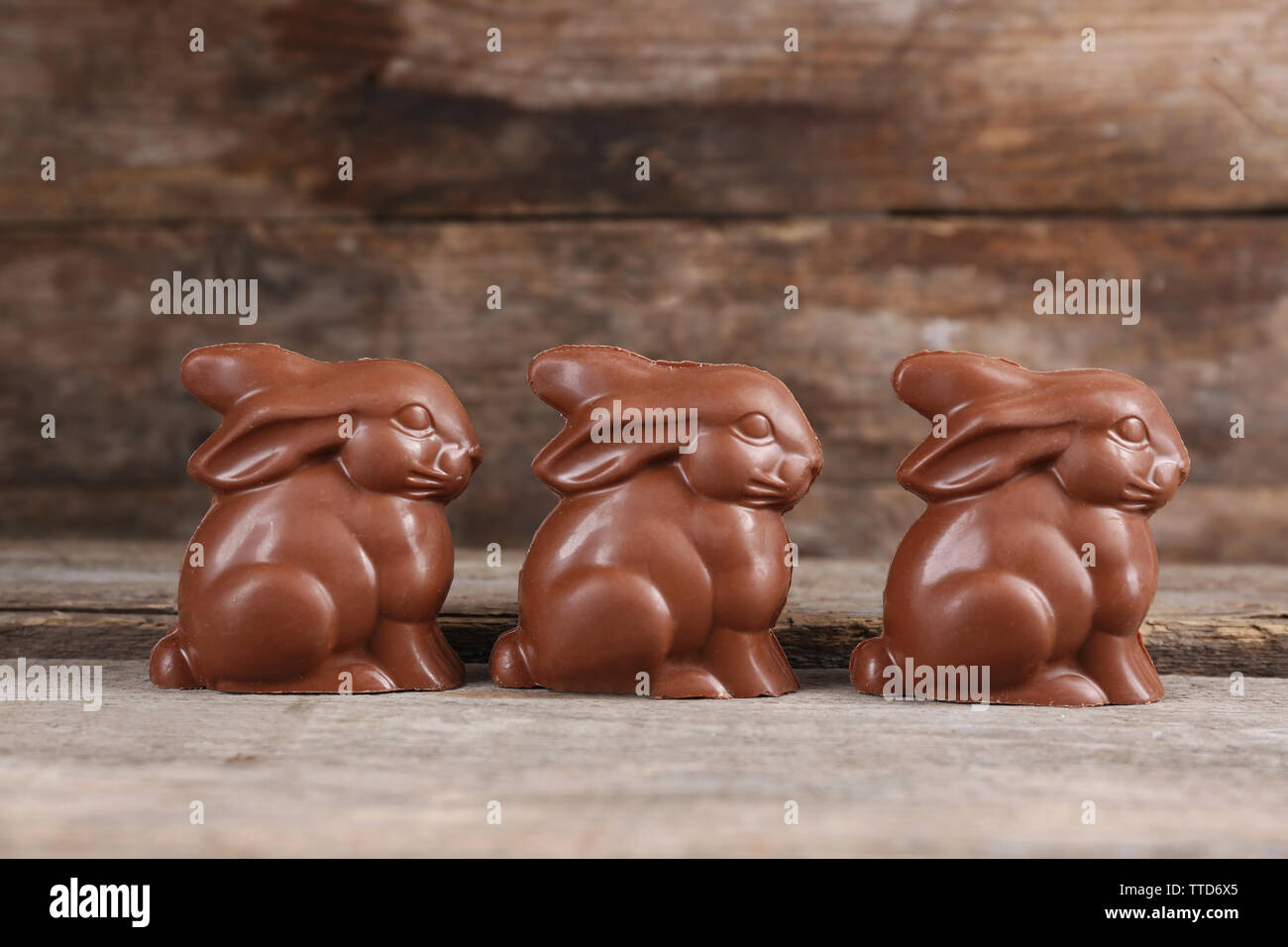 Chocolate Easter bunnies on wooden background Stock Photo