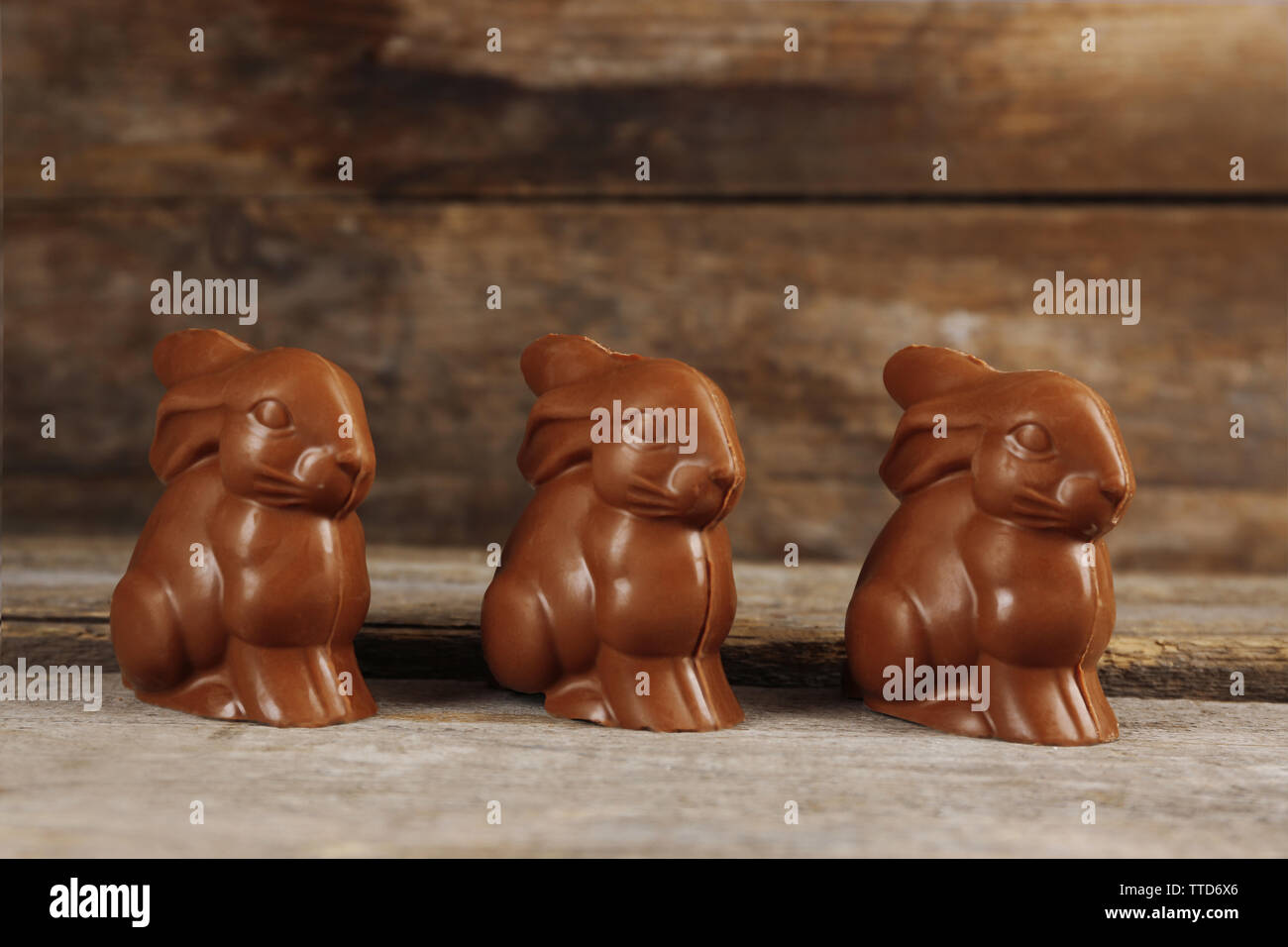 Chocolate Easter bunnies on wooden background Stock Photo