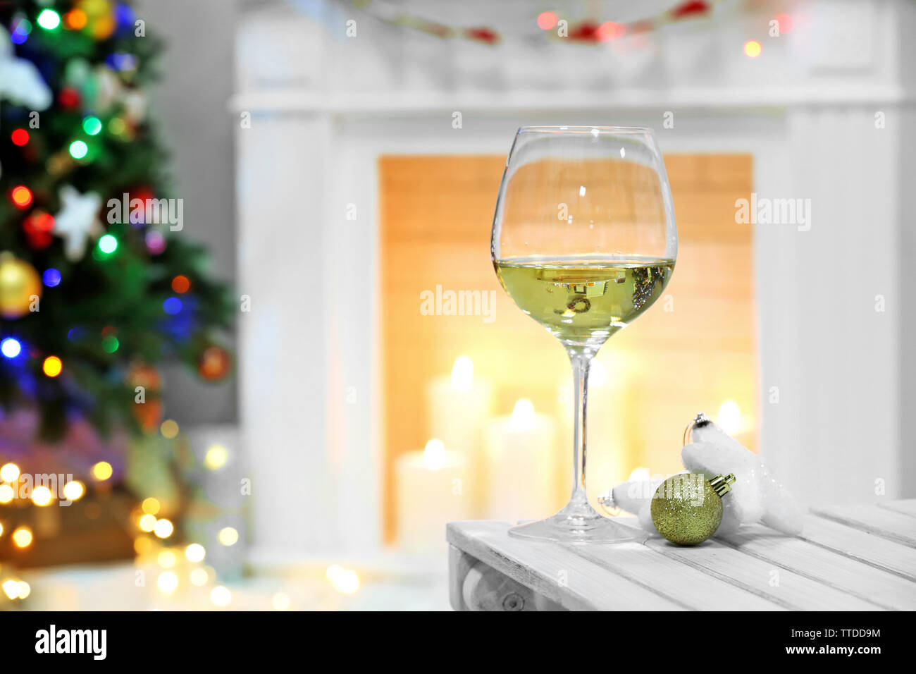 Wine Glass With Christmas Decor On Fireplace Background Stock