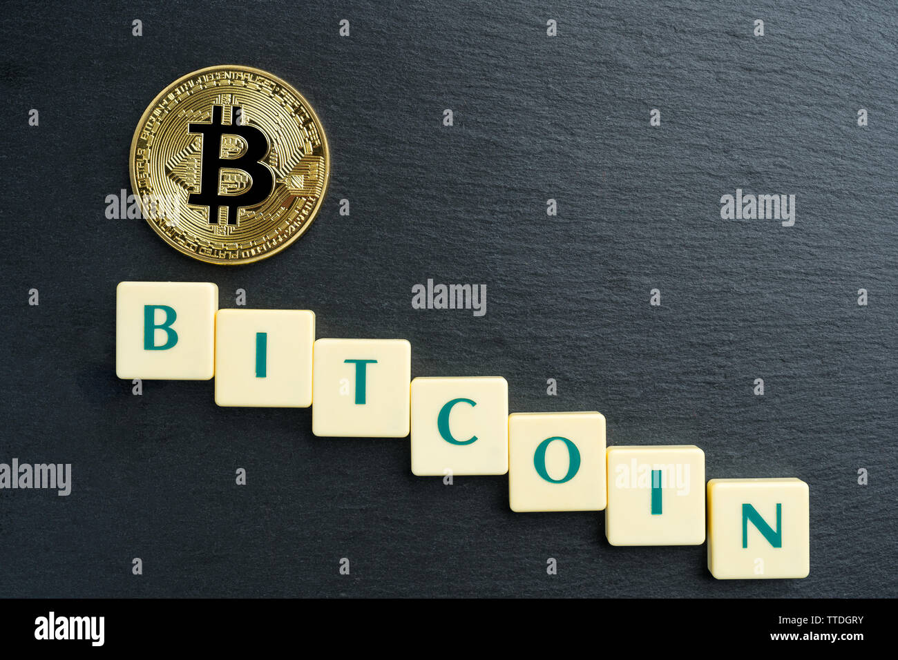 Physical Bitcoin gold coin with text made out of letter tiles.  Cryptocurrency decline or bear market. Copy space in the top right corner  Stock Photo - Alamy